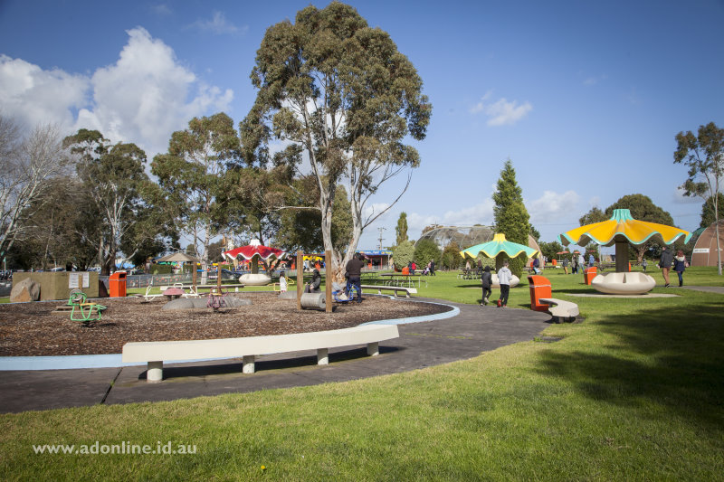 View of gardens with play equipment and tables.