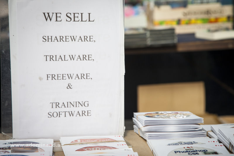 Sign advertising the sale of shareware and freeware beside copies of Adobe Photoshop.